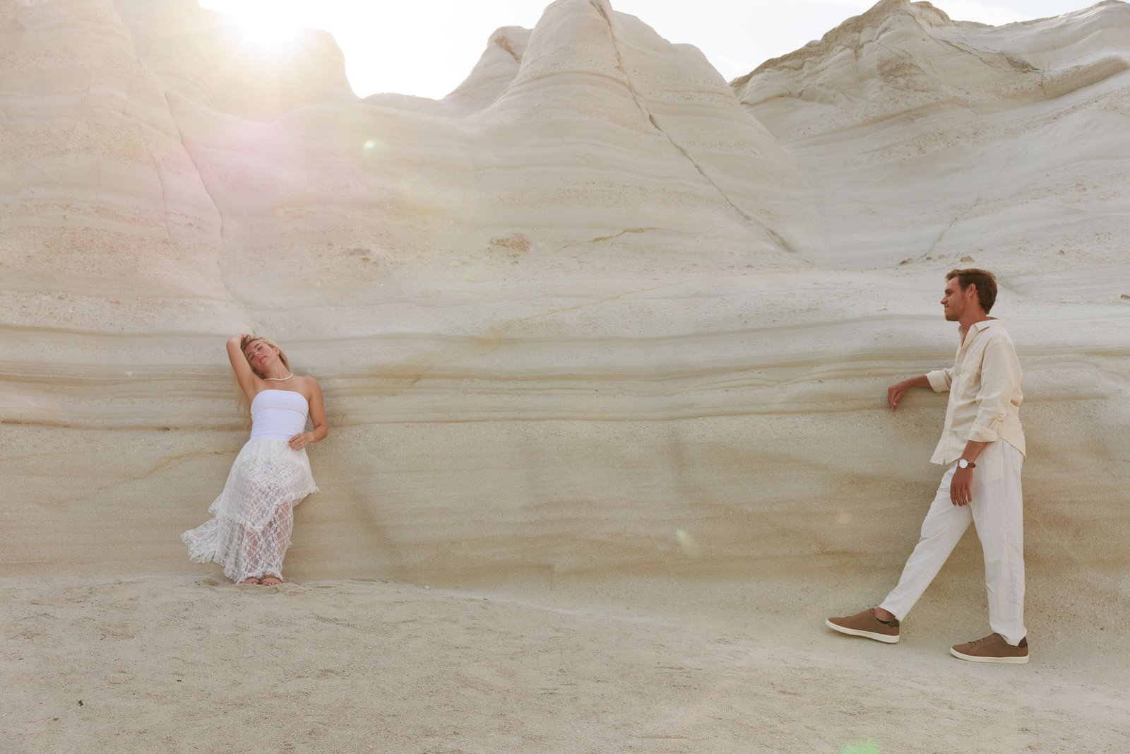 Engaged couple posing among the white rock formations of Milos, Greece during a destination engagement session